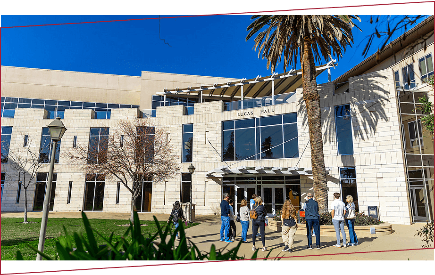 Exterior of Lucas Hall on Santa Clara campus with students in front