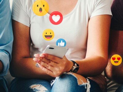 Group of people sitting together with social media reaction icons.