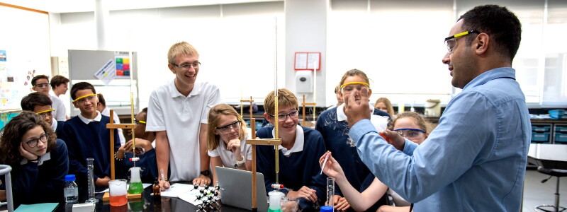 A teacher leads students in a chemistry activity