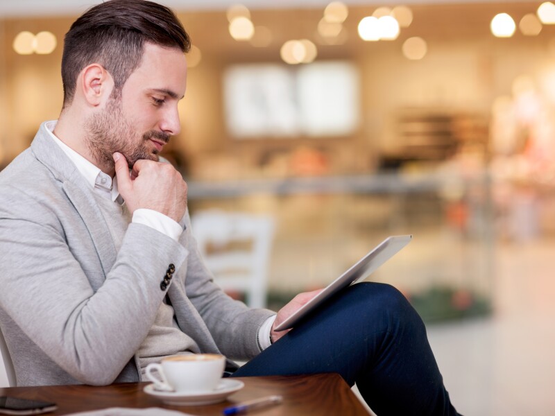 young businessman working on a digital tablet in a cafe