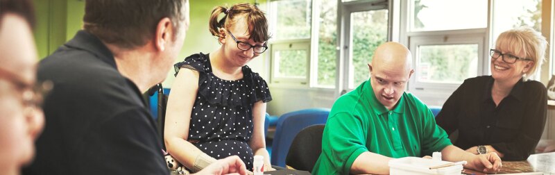 Teachers in a classroom supporting disabled students with transition planning.