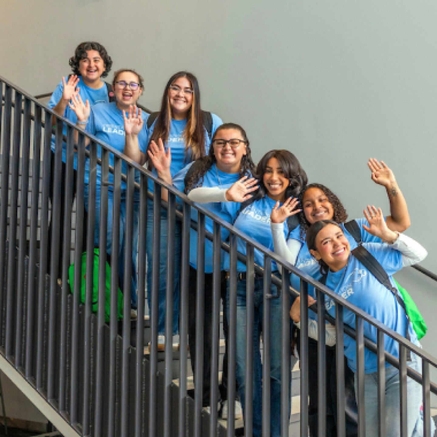 Group of female CSUMB students smile while standing on stairs.