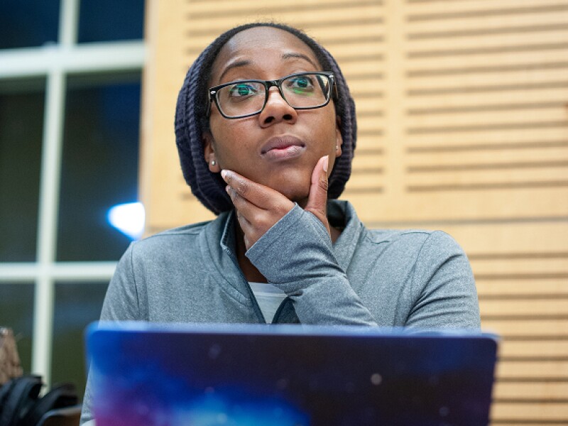 Student in deep thought at her laptop