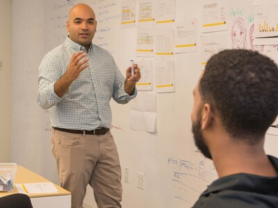A group of people working around a whiteboard.