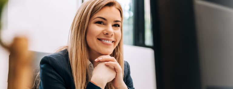 Happy woman sitting at her work desk