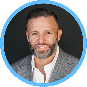 A headshot of Michael Bell, Chief Marketing Officer at Everspring, smiling and wearing a gray suit with a white shirt. The image is framed within a circular blue border, with a solid dark background.