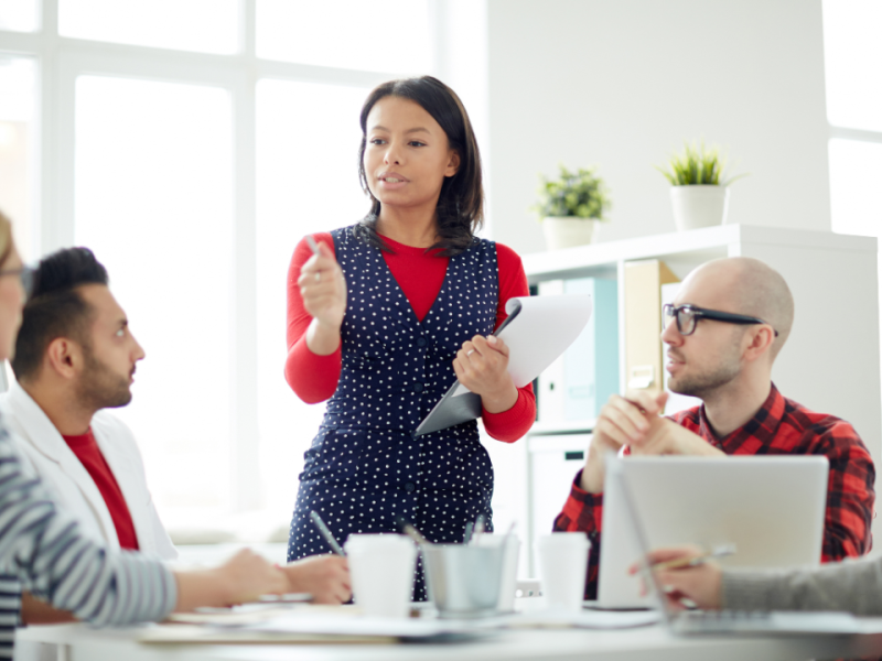 A manager leads a team meeting