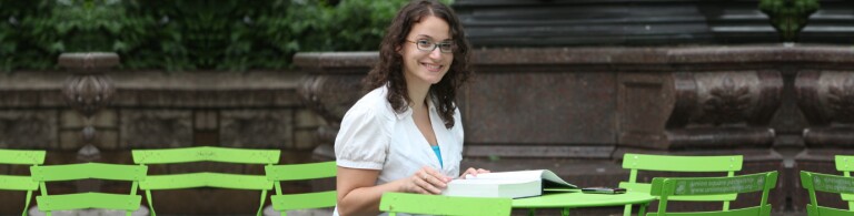 Student works at a table in NYC park