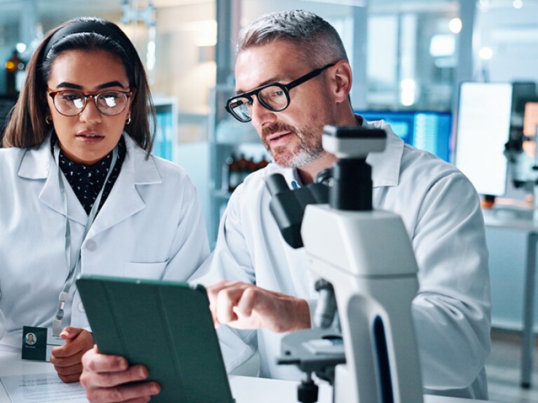 Two people in lab together conducting research