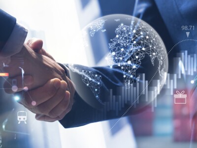 two men shaking hands with supply chain symbols surrounding them