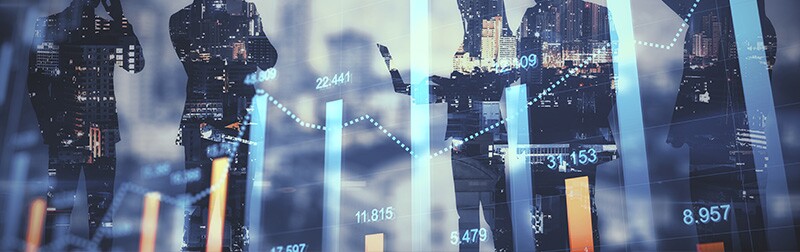 Superimposed in front of  silhouettes of people in business attire, a graph shows numbers going up.