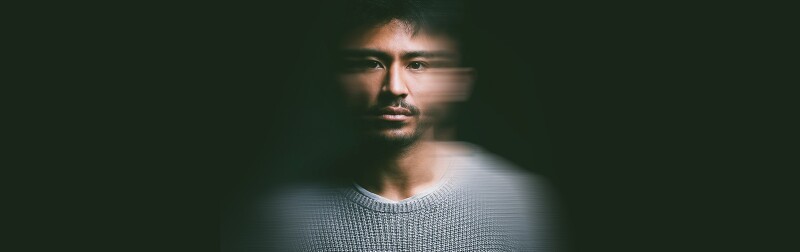 Portrait of young man with blurry face experiencing PTSD