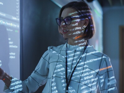 female teacher projecting a presentation with an artificial intelligence neural network architecture.