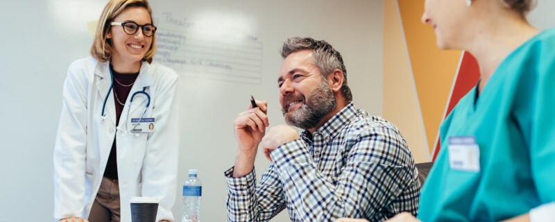 healthcare workers surrounding boss