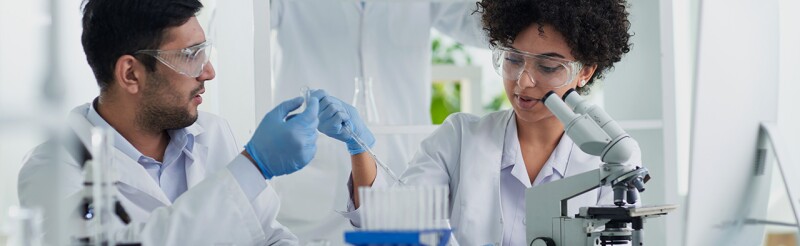 Diverse team of biomedical engineers working together in a lab