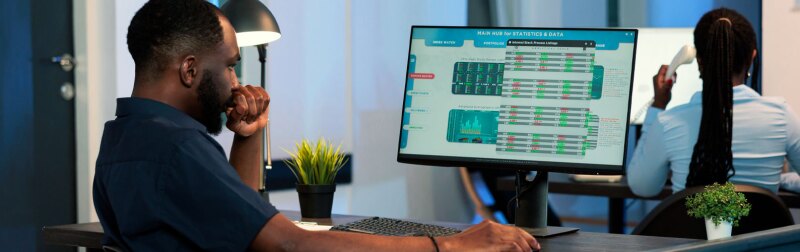 Hedge fund manager looking at stock marketing exchange statistics with global money trade and profit on computer screen.