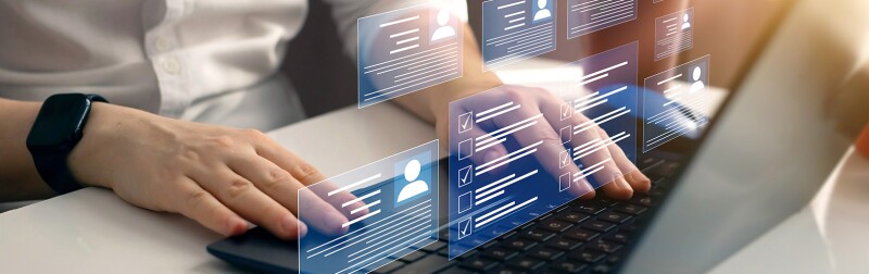 Person at laptop, analyzing customer data.