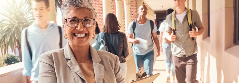principal smiling in front of students