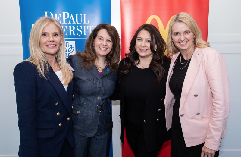 Four women in business attire attending DePaul University event