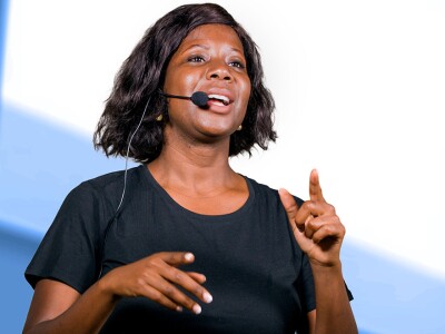 Woman with headset speaking at a conference