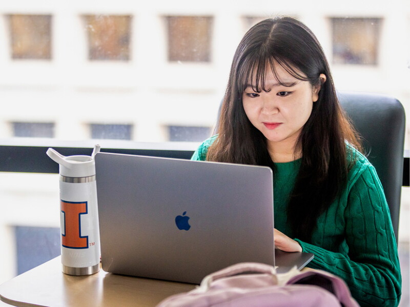 Female student focused on her laptop.