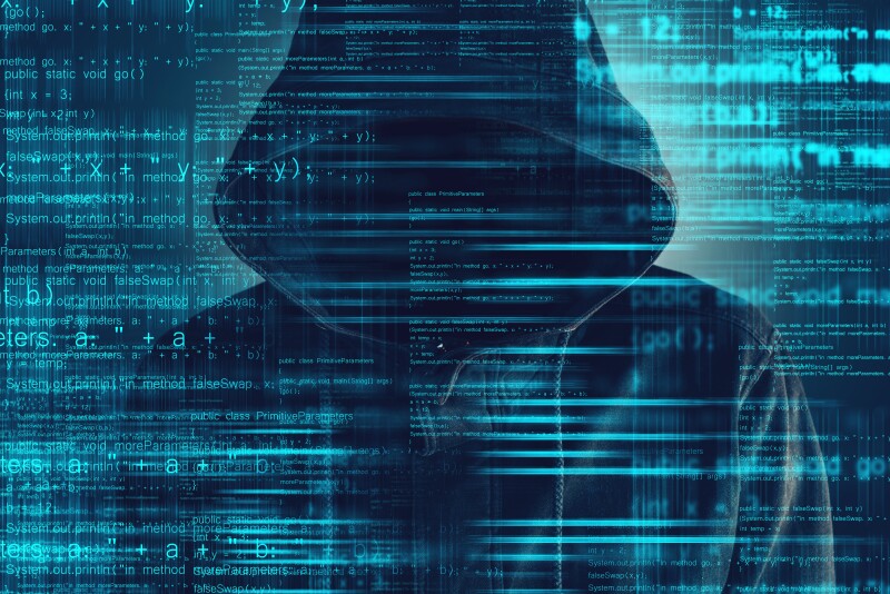 Cyber hacker wearing hoodie with code overlay