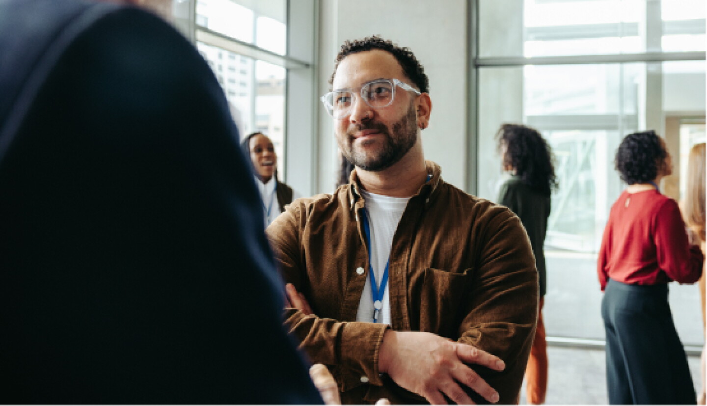 A male CWRU student listening to a alumni during a meet and greet event.