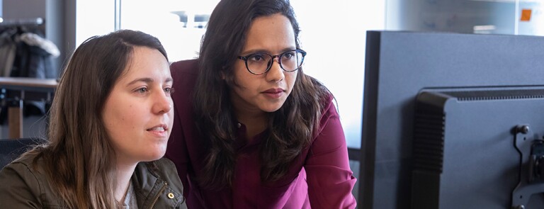 Two women looking at a computer screen