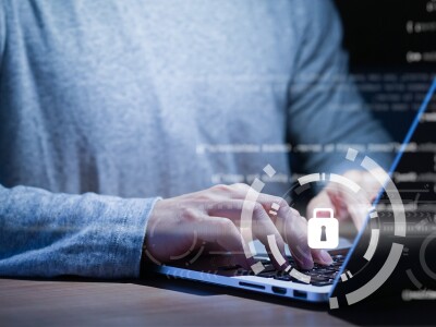 close up of programmer typing on computer with code