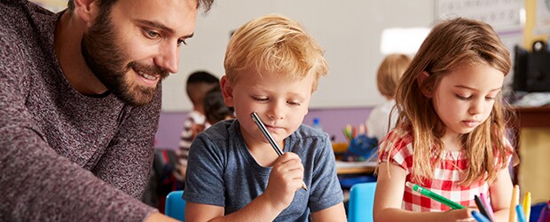 Man with boy and girl in classroom