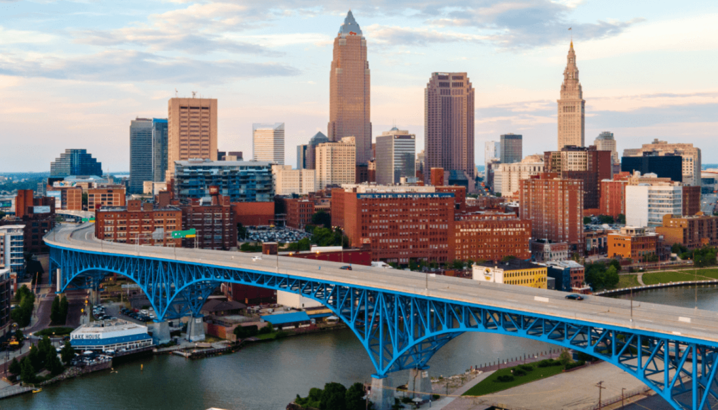 City skyline overlooking a river with bridge