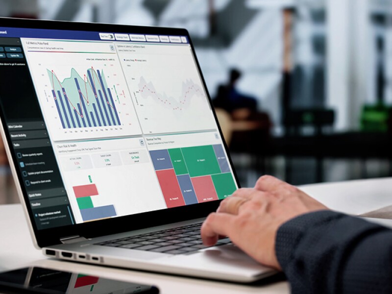 Man analyzing data charts on his laptop in a cafe