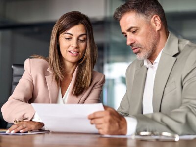 Two people looking over a document.