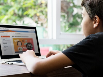 Group of young students using laptops in a classroom