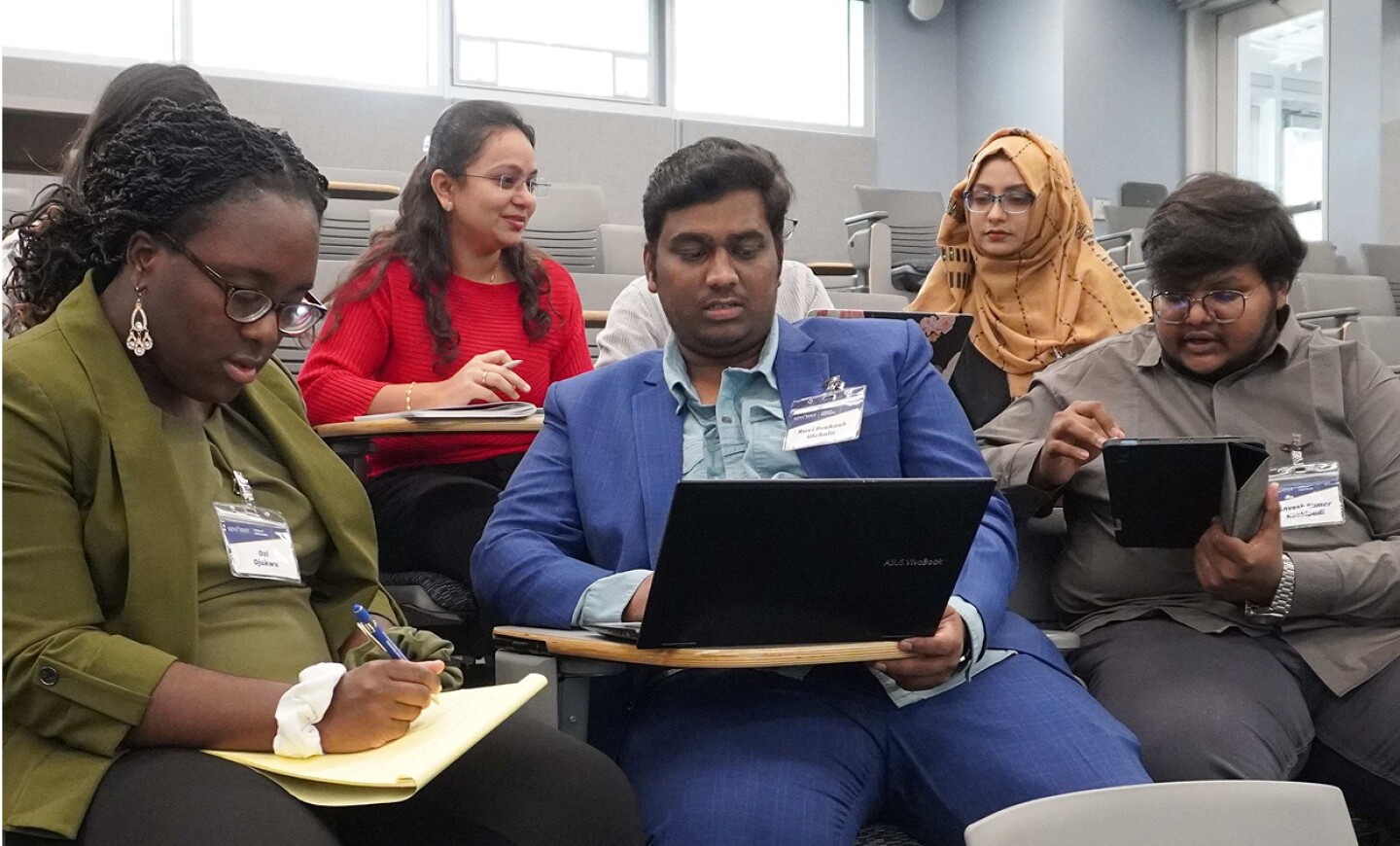 Group of student in a classroom with laptops and notebooks