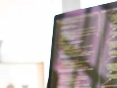 man on computer looking at code