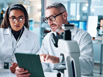 Two people in lab together conducting research