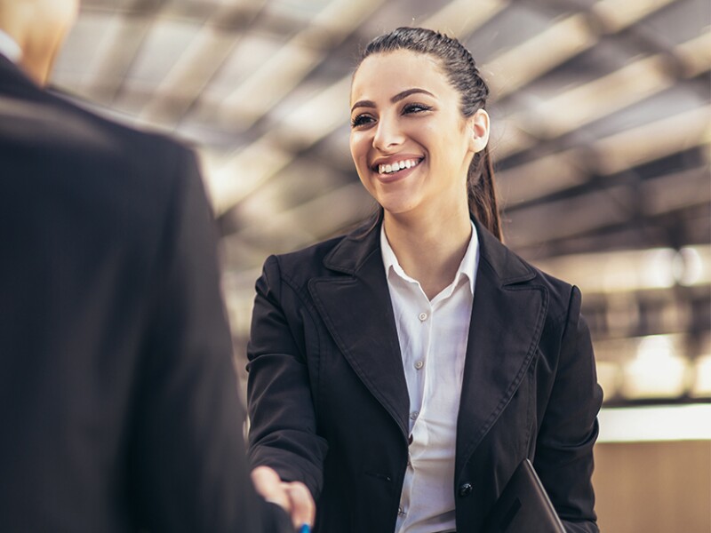 woman shaking hands with businessman
