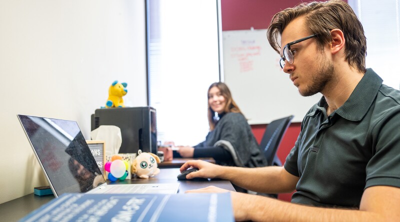 Marquette student working at his laptop