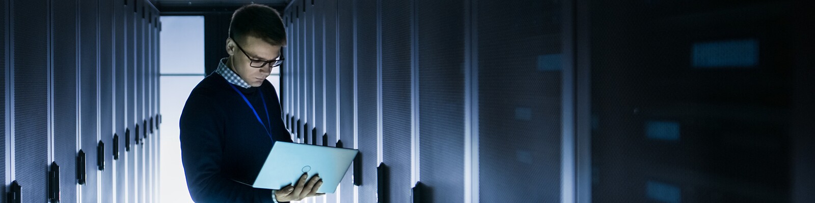 man-on-laptop-in-server-room