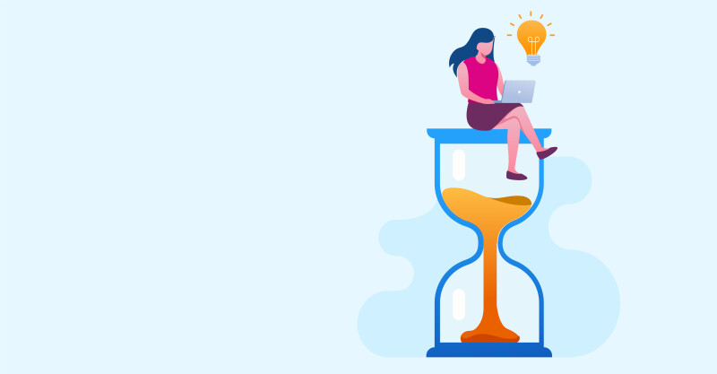 A woman working on a laptop, near a timer.