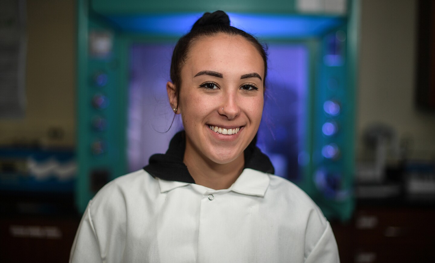 Smiling female student in a lab setting