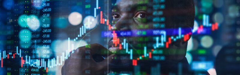 Portrait of Black Stock Market Trader Doing Fintech Analysis.