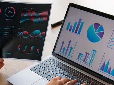 A person reviewing statistical patterns on a laptop