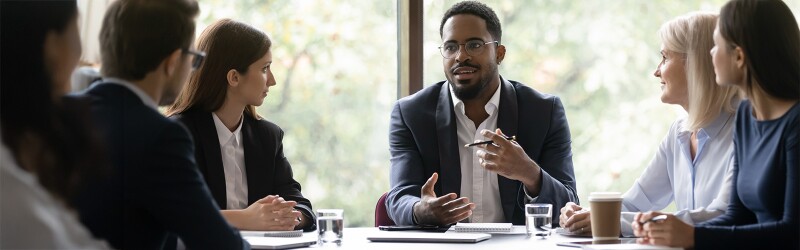 MBA graduate leading a meeting