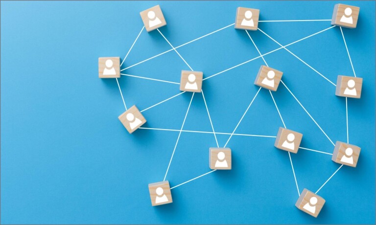 Wooden blocks connected with string against blue background