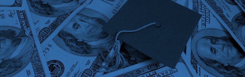Graduation cap on top of dollar bills