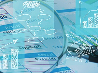 magnifying glass looking at numbers for forensic accounting