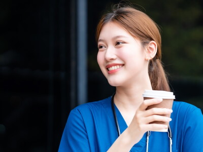 A nurse looks refreshed and happy after a break outdoors.
