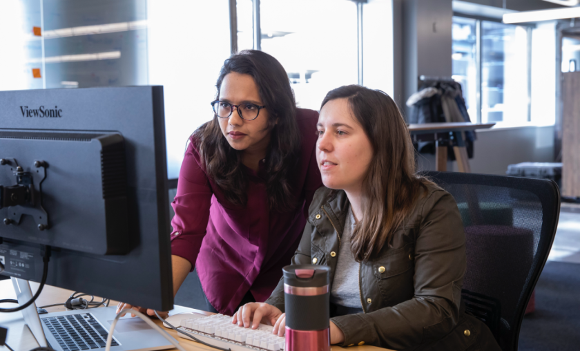 Two Marquette students working together on a computer